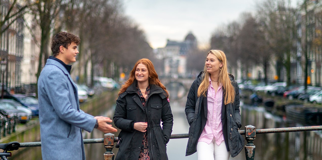 Students in Amsterdam hanging out by the canals